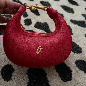 Red Pebbled Leather Crescent Crossbody Bag with Gold Accent